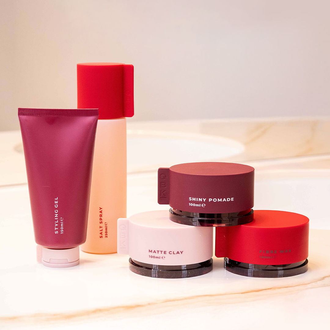 Skincare products in various containers arranged on a light surface.