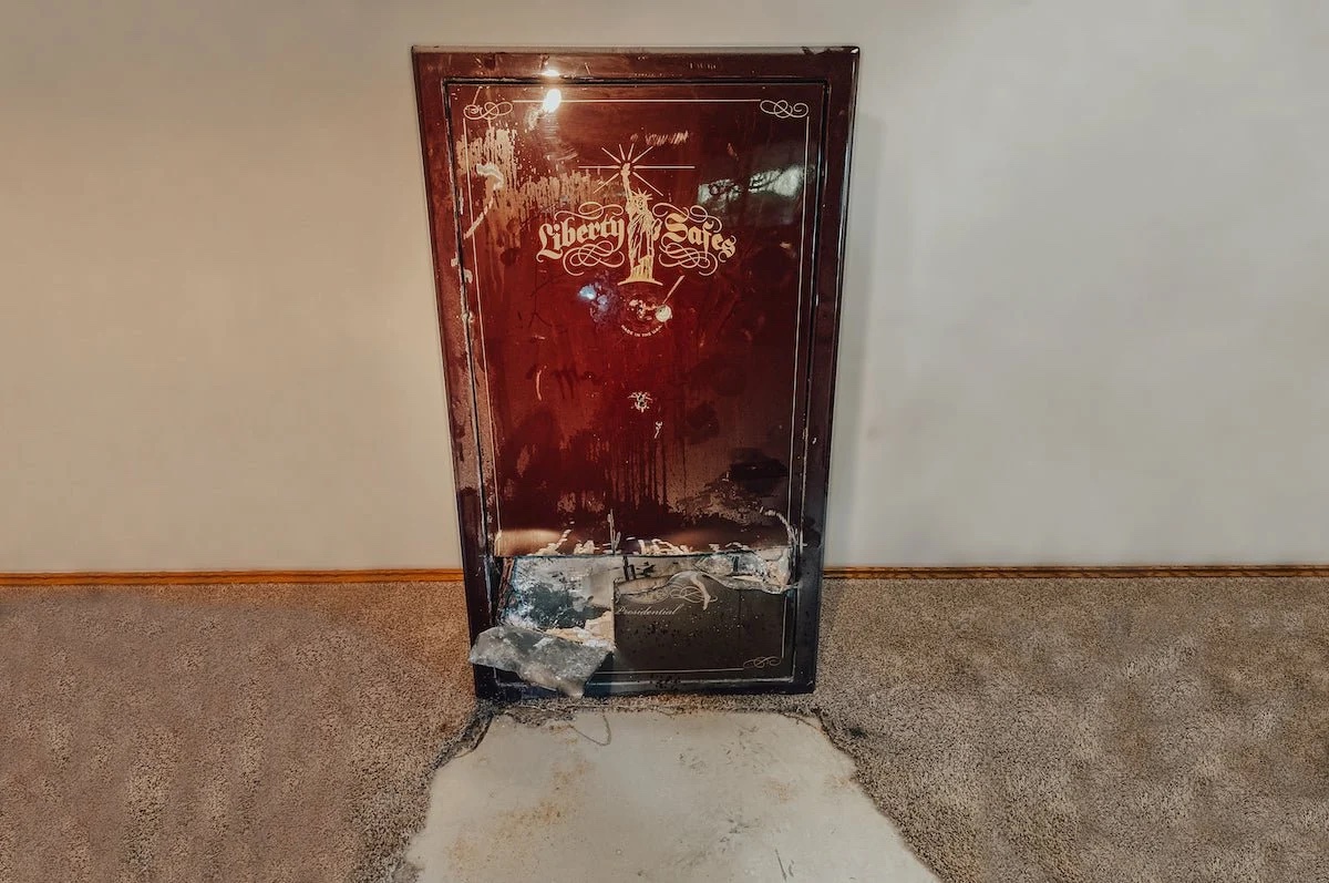 Old, damaged cabinet with visible wear and a carpeted floor.