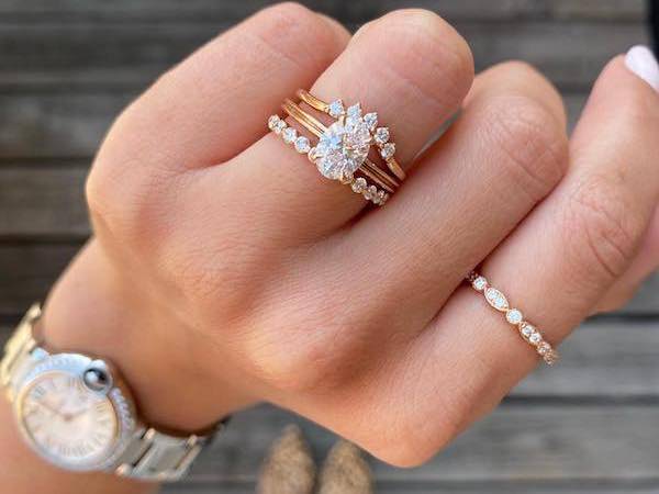 hand with several diamonds rings