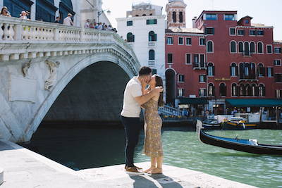 couple kissing under the rialto bridge, venice