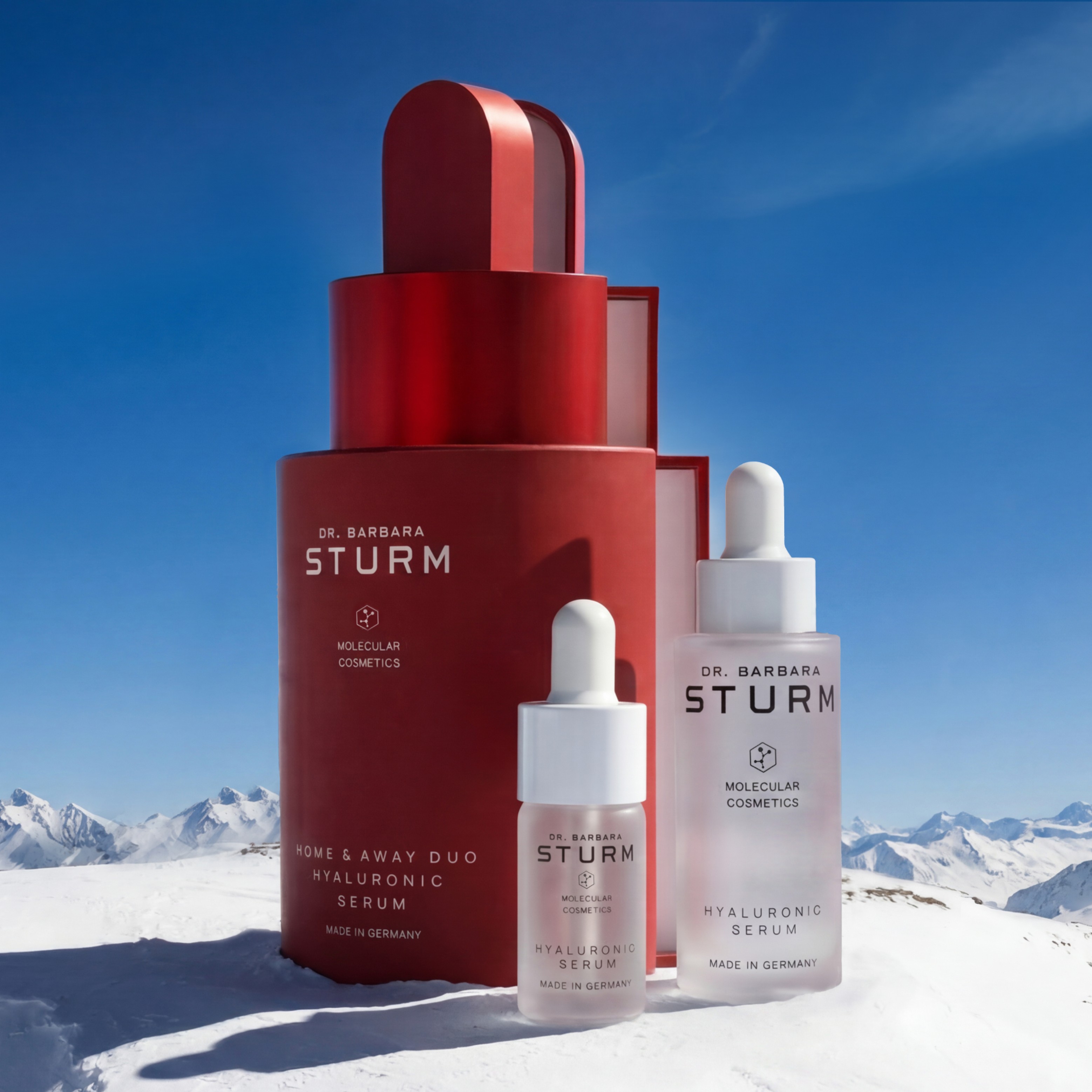 Skincare products displayed against a snowy mountain backdrop.