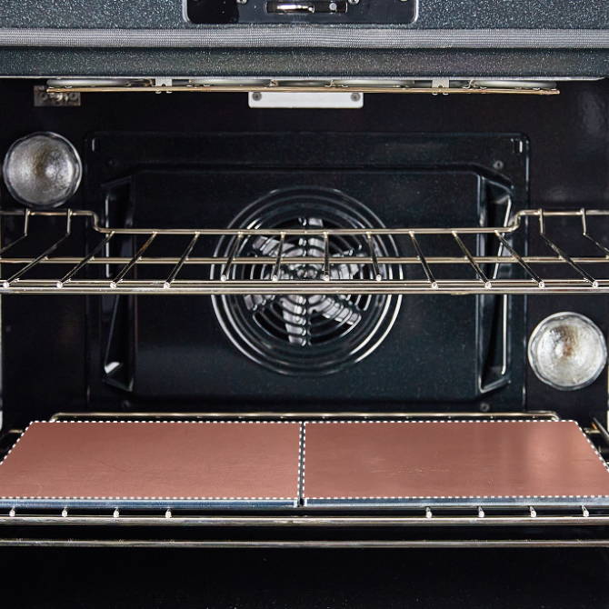 An oven interior with two racks. The lower rack has two Misen Oven Steels placed side by side.