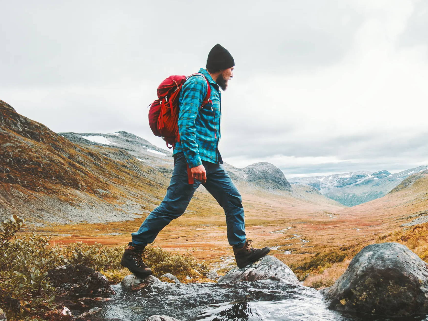 Man hiking through the mountains with a backpack