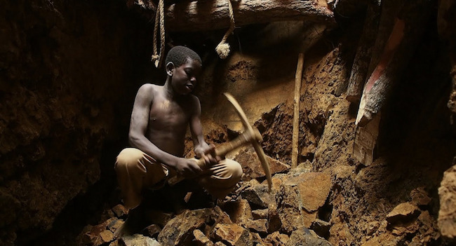 child working in an open pit gold mine