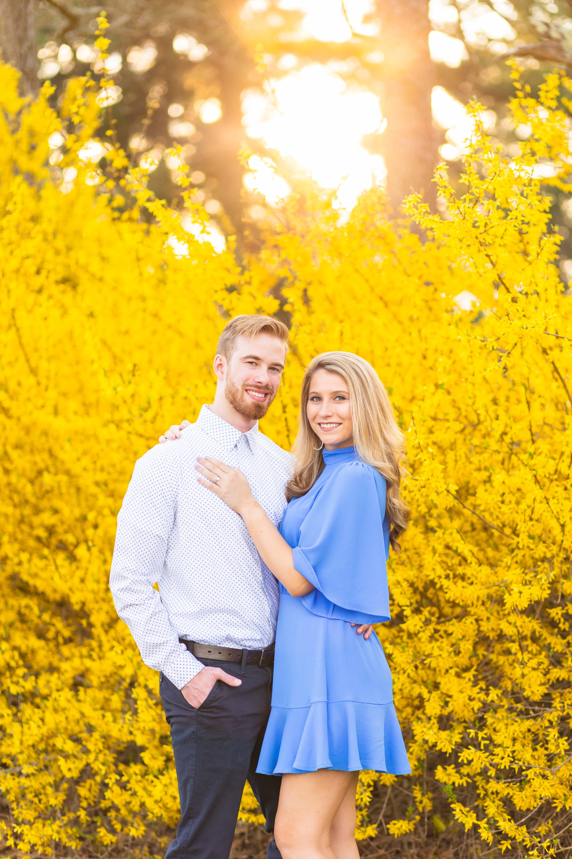 Henne Engagement Ring Couple Kyle & Alyssa Amidst a Backdrop of Yellow Flowers at Sunset