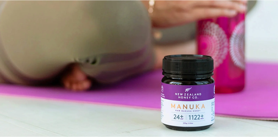Supplement bottle on yoga mat with water bottle in background.