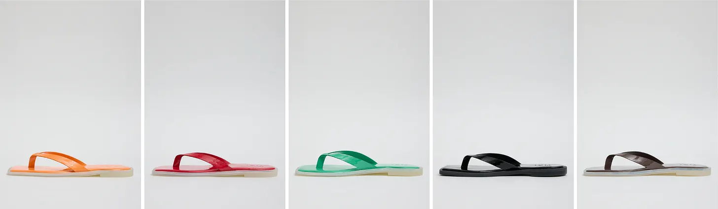 A row of colorful flip-flops on a neutral background.