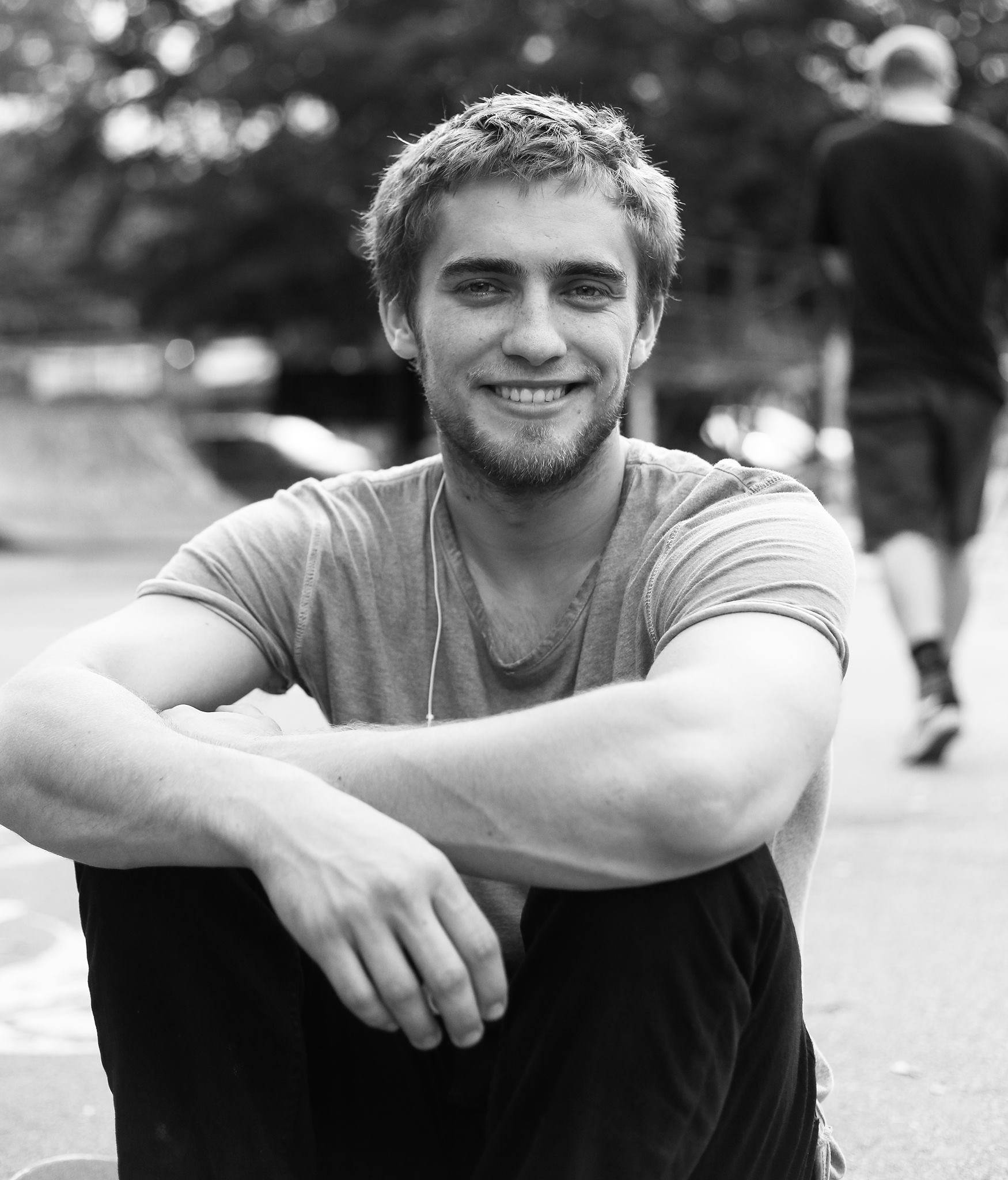 man at skate park wearing t-shirt and black jeans