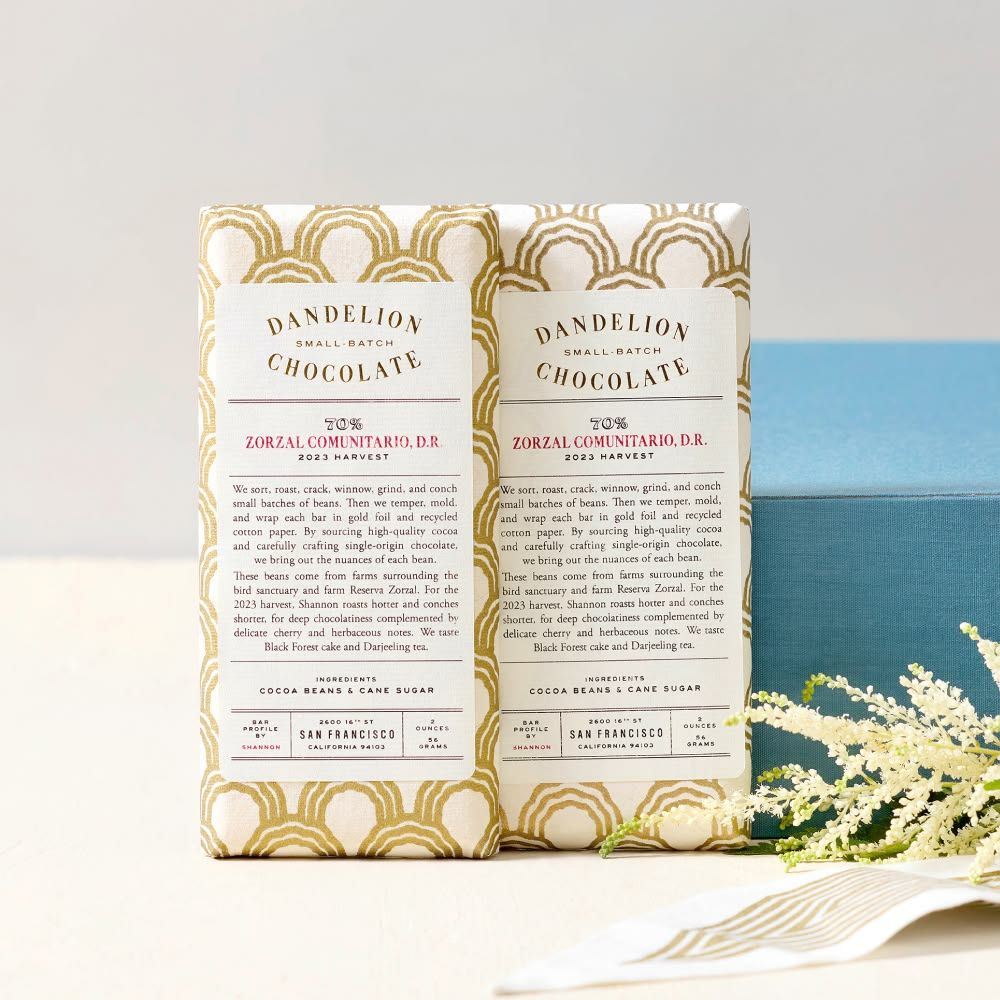 Two chocolate bars with decorative packaging and text details.