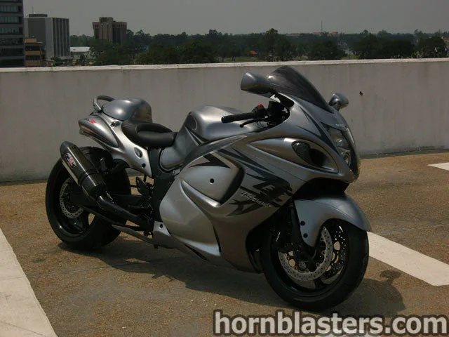 Close-up compact electric horn mounting point on Del's Suzuki Hayabusa with bracket fasteners and surrounding wiring photo 3