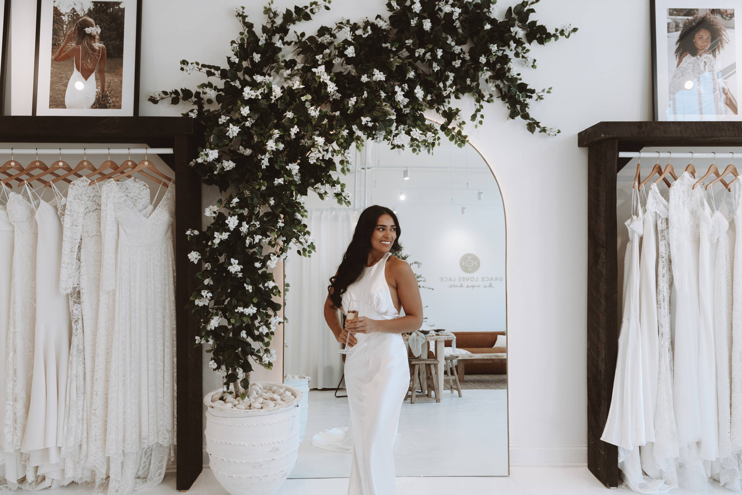 Hanging Grace Loves Lace dresses in the Minneapolis showroom and bride wearing the Opal gown