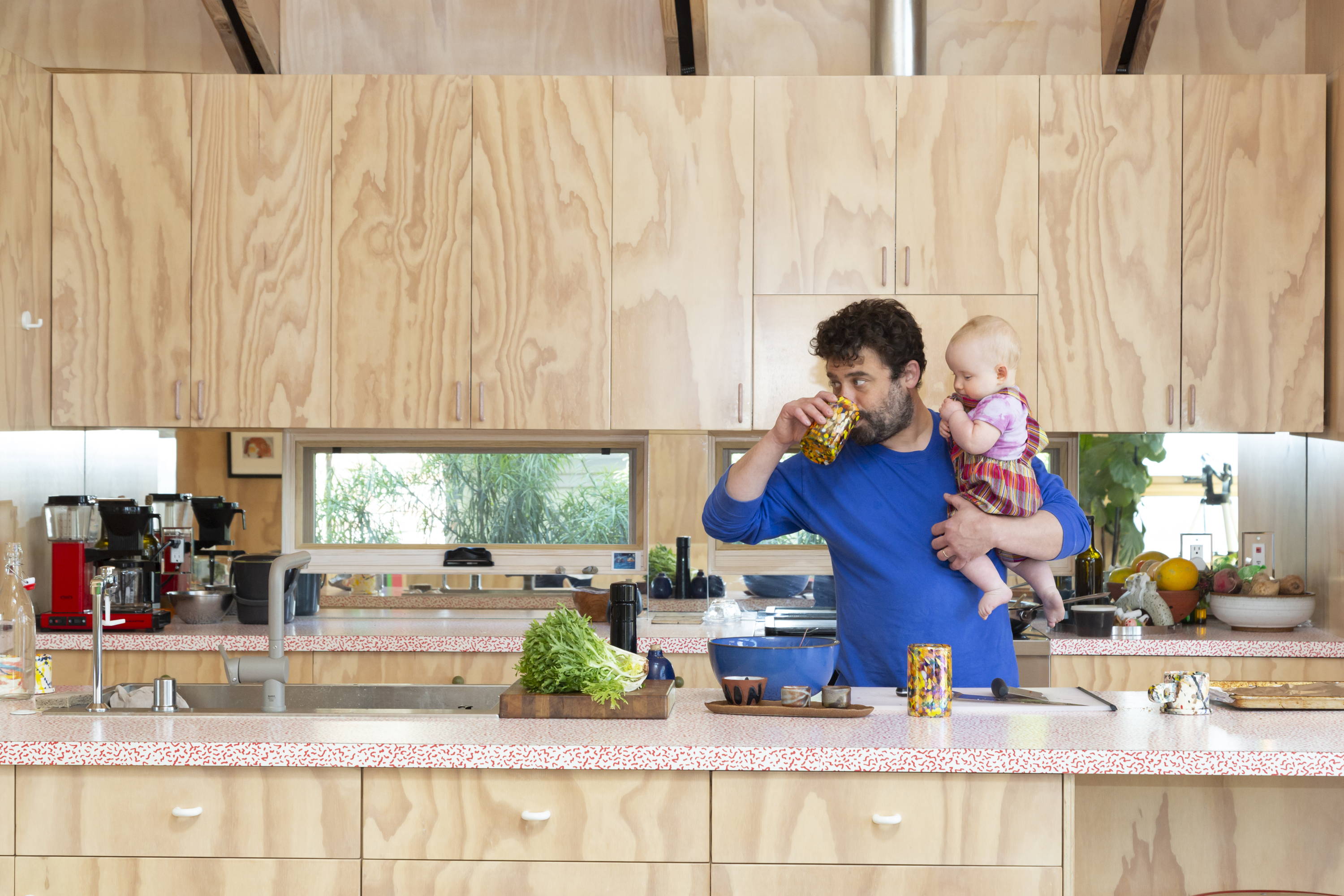 Dad and child in eco friendly, sustainably built kitchen
