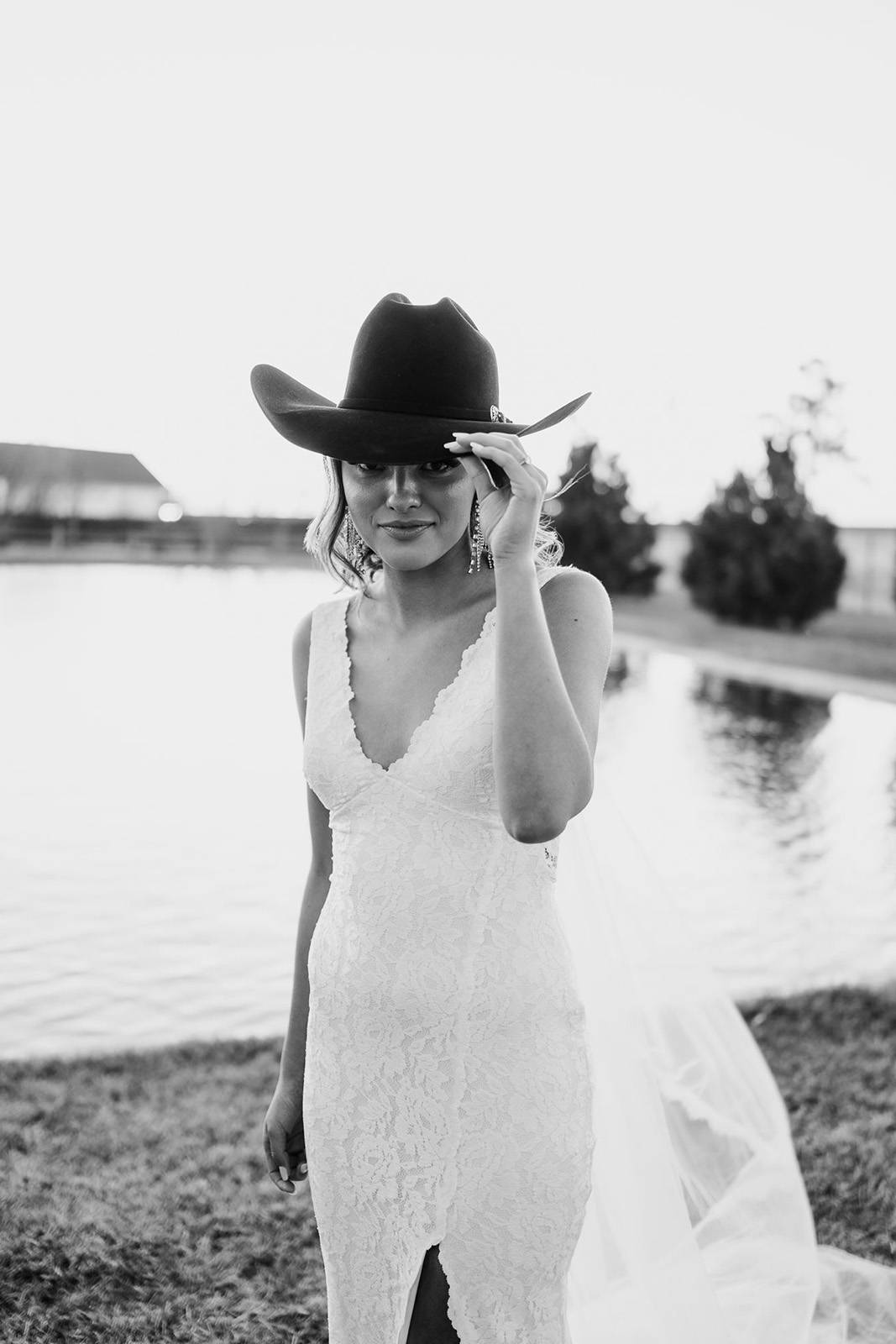 Bride in our Lumi gown wearing a cowboy hat