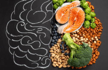 Healthy foods arranged with a brain outline, symbolizing nutrition and mental health.