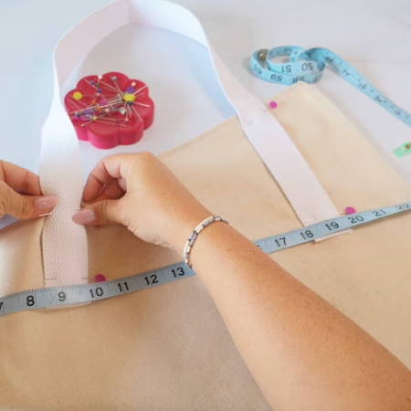 White cotton belting handles pinned at an angle on the fresh cut flower tote bag