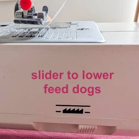 Feed dog button on a Pfaff sewing machine