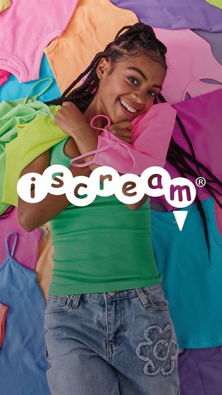Young person smiling, holding colorful clothing, with the brand name 