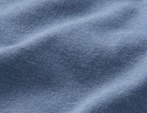 Close-up of soft, textured blue fabric with gentle folds and creases.