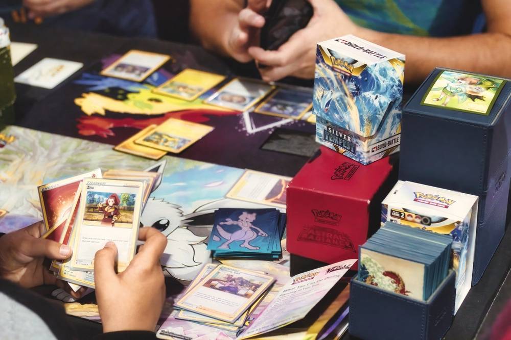 kids playing with Pokemon trading cards on a table