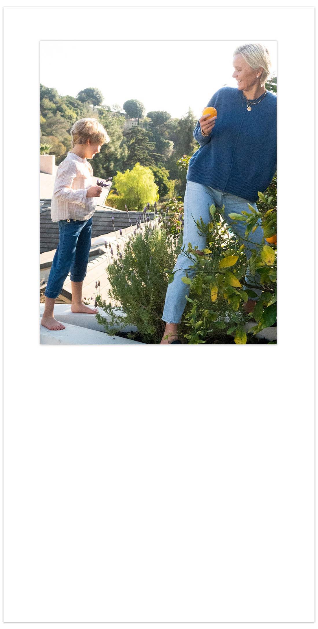 Dr Barbara Sturm and Pepper picking oranges from tree