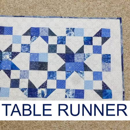rectangular quilted table runner in winter colors, blue and whites