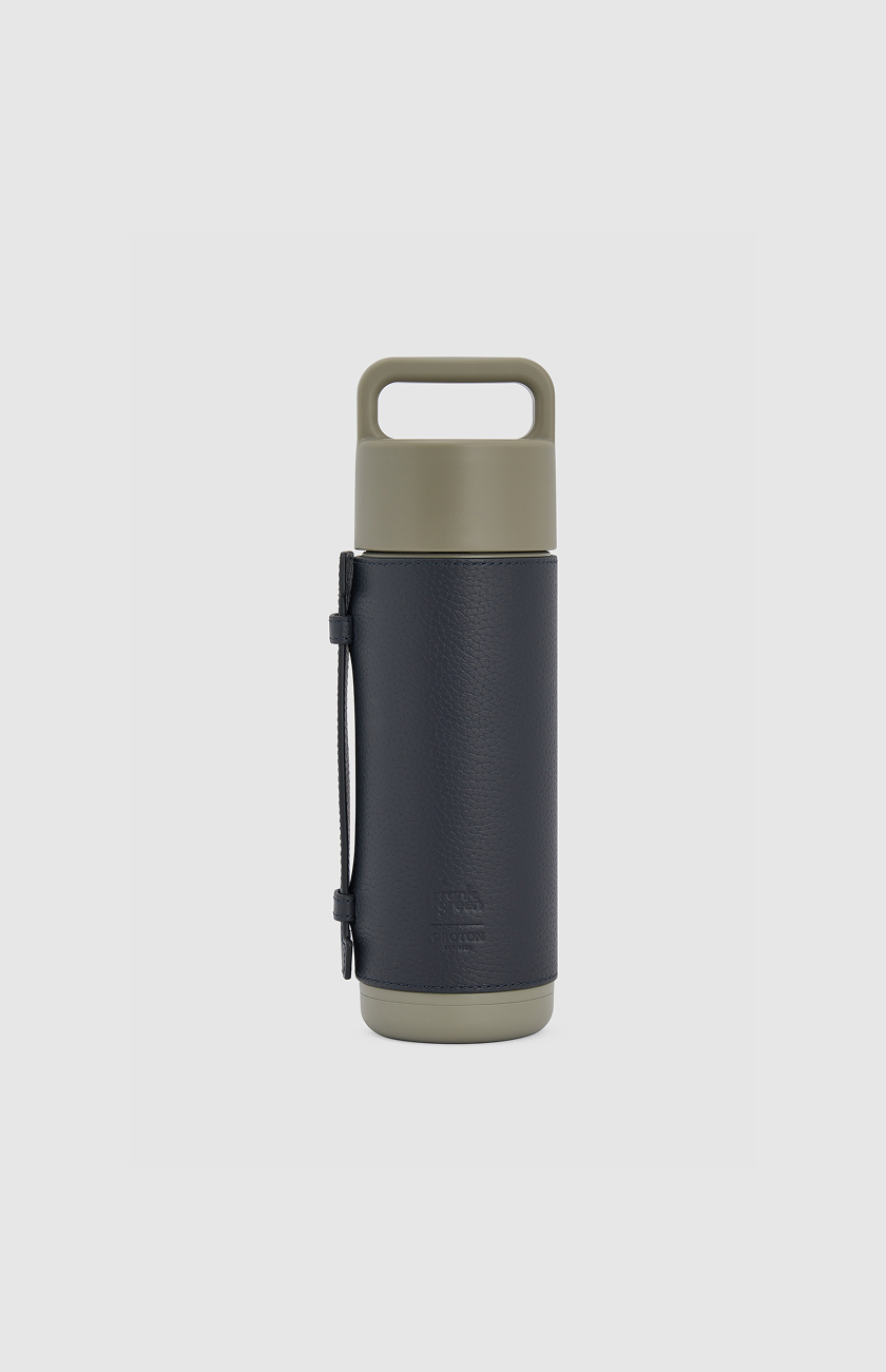 A sleek, modern insulated water bottle in dark blue and olive green.