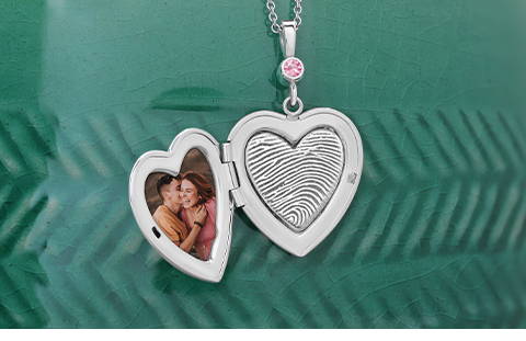 open sterling silver heart shaped locket with picture and engraved fingerprint on the inside