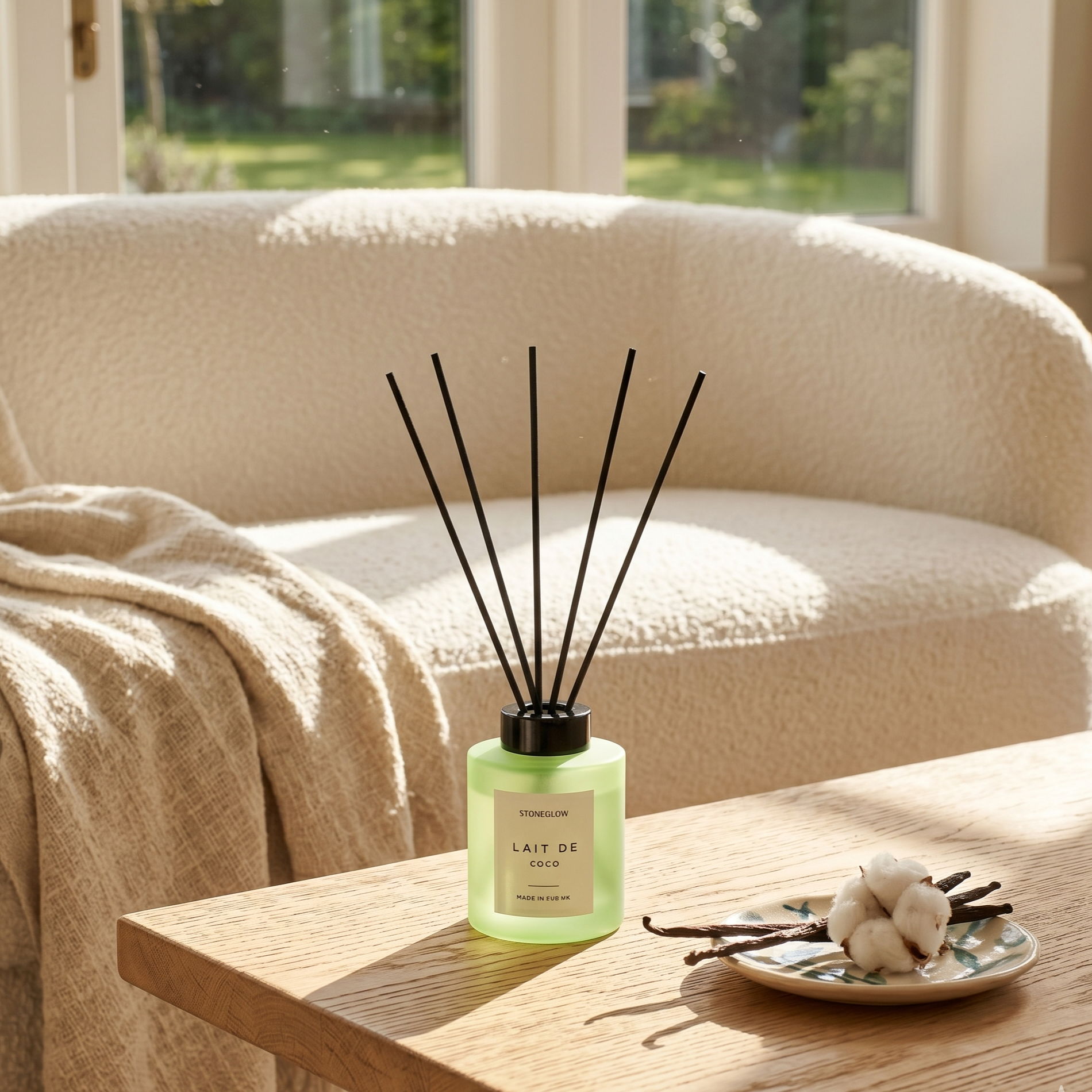 A cozy living room with a diffuser and decorative items on a table.