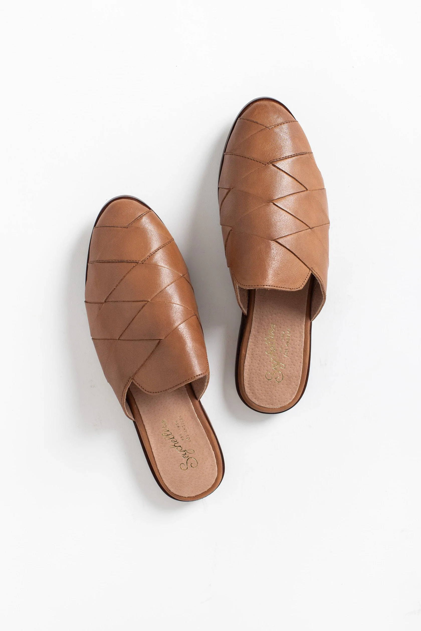 A pair of brown leather slip-on flats