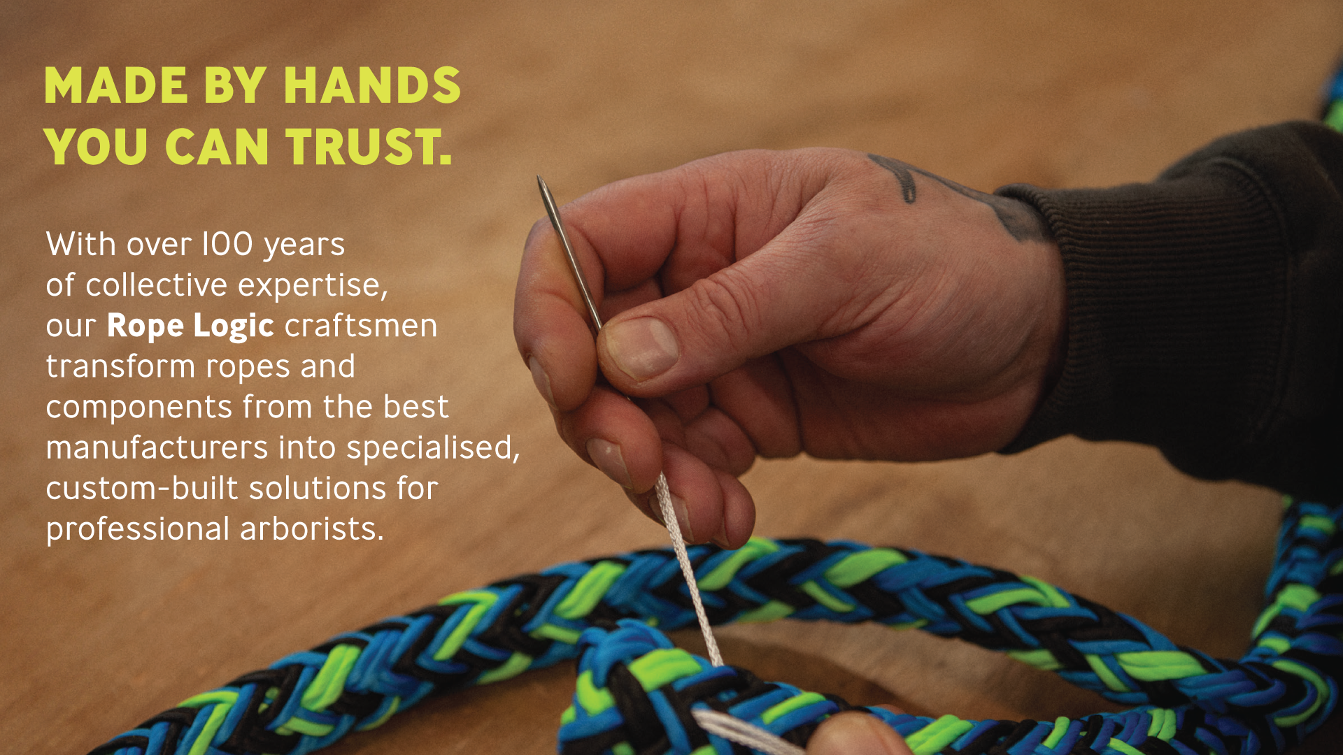 A person sewing colorful ropes with a needle.