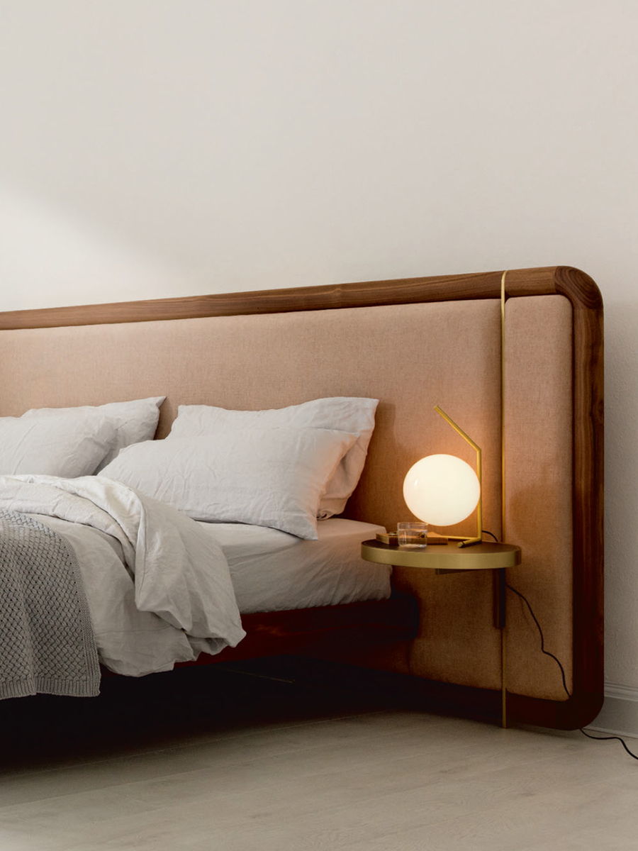 A Porada modern bedroom with a bed and a glowing round lamp.