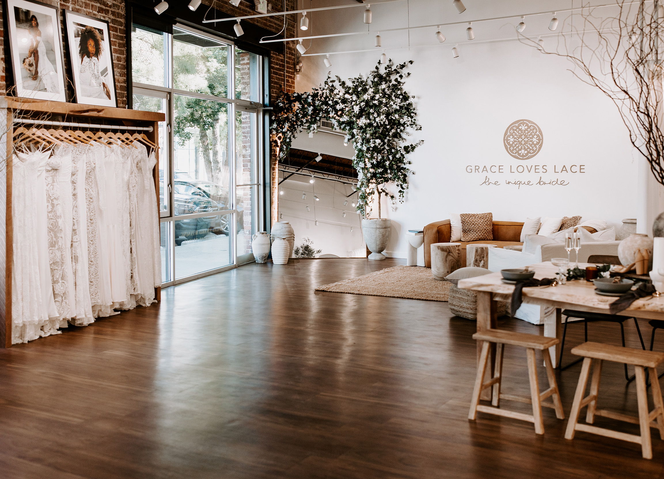 A stylish boutique interior with clothing racks and seating area.