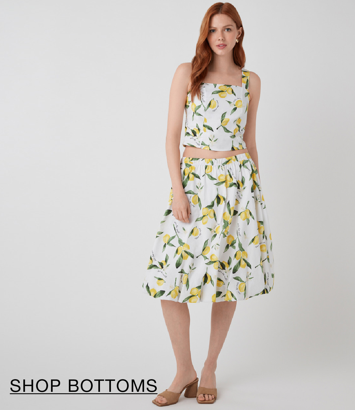 Woman in a floral two-piece outfit with a skirt and top.