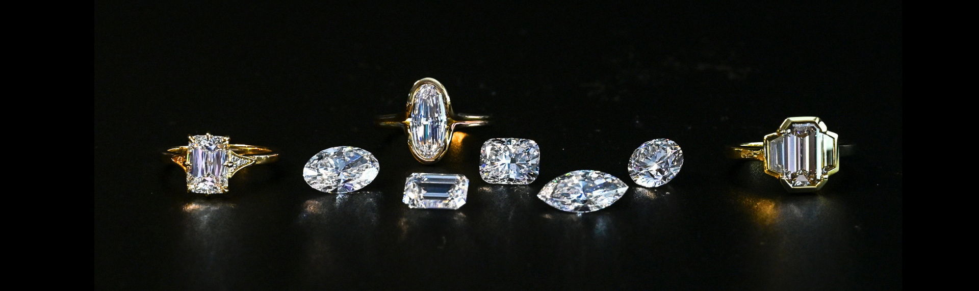various larger center diamond Henne Jewelers rings and loose diamonds