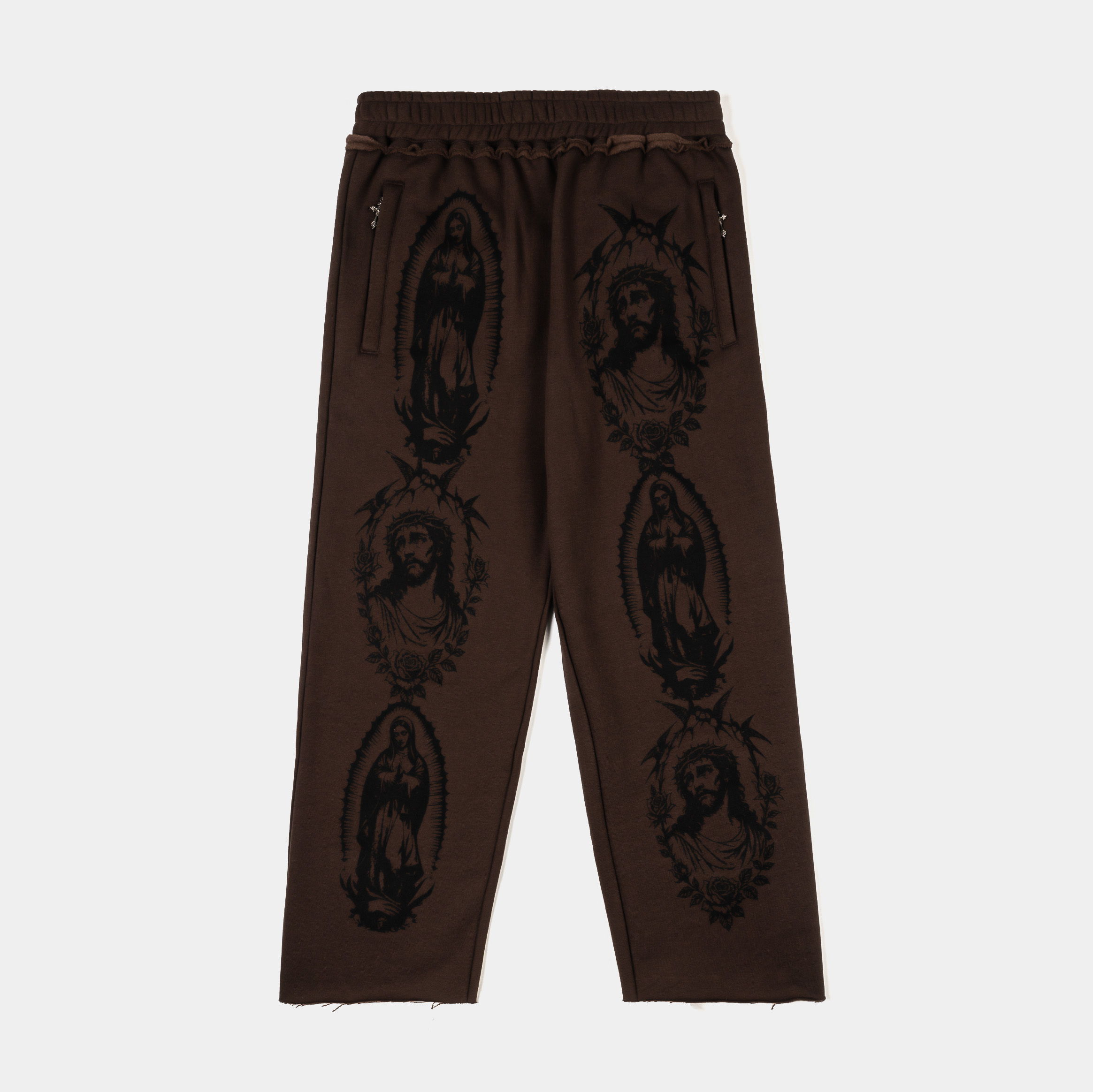 Brown pants featuring black graphic designs of figures.