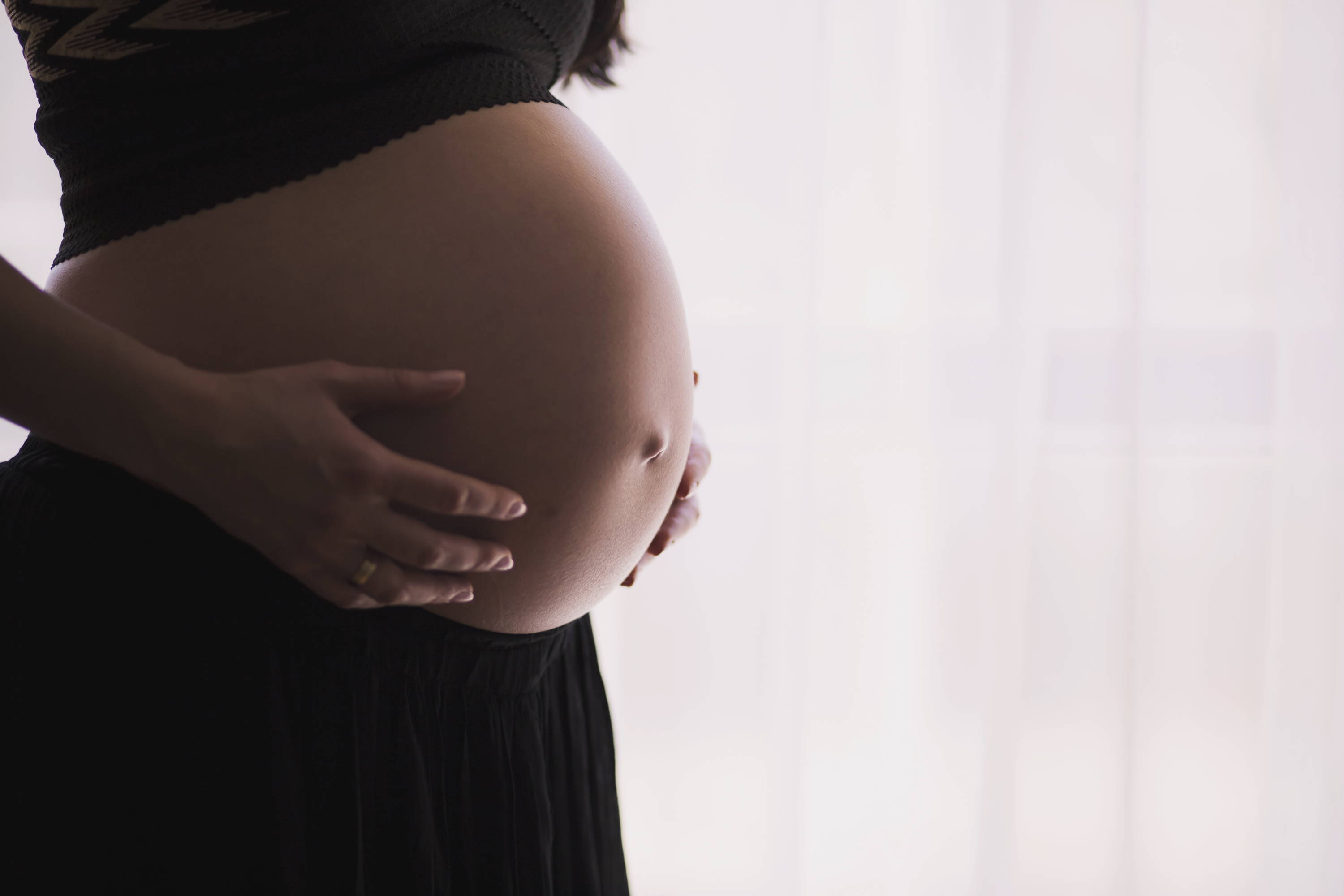 Woman Holding Pregnant Stomach