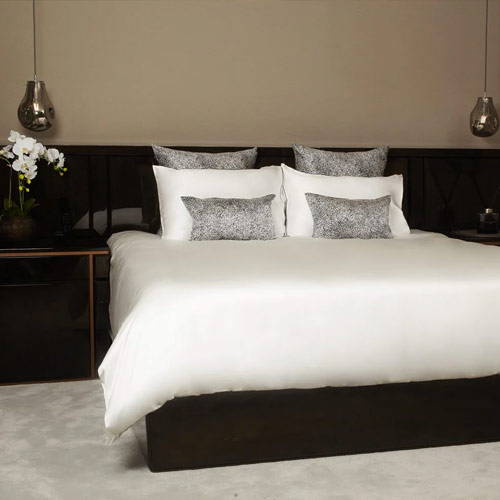 silk cushion covers and silk pillowcases on a white silk bed