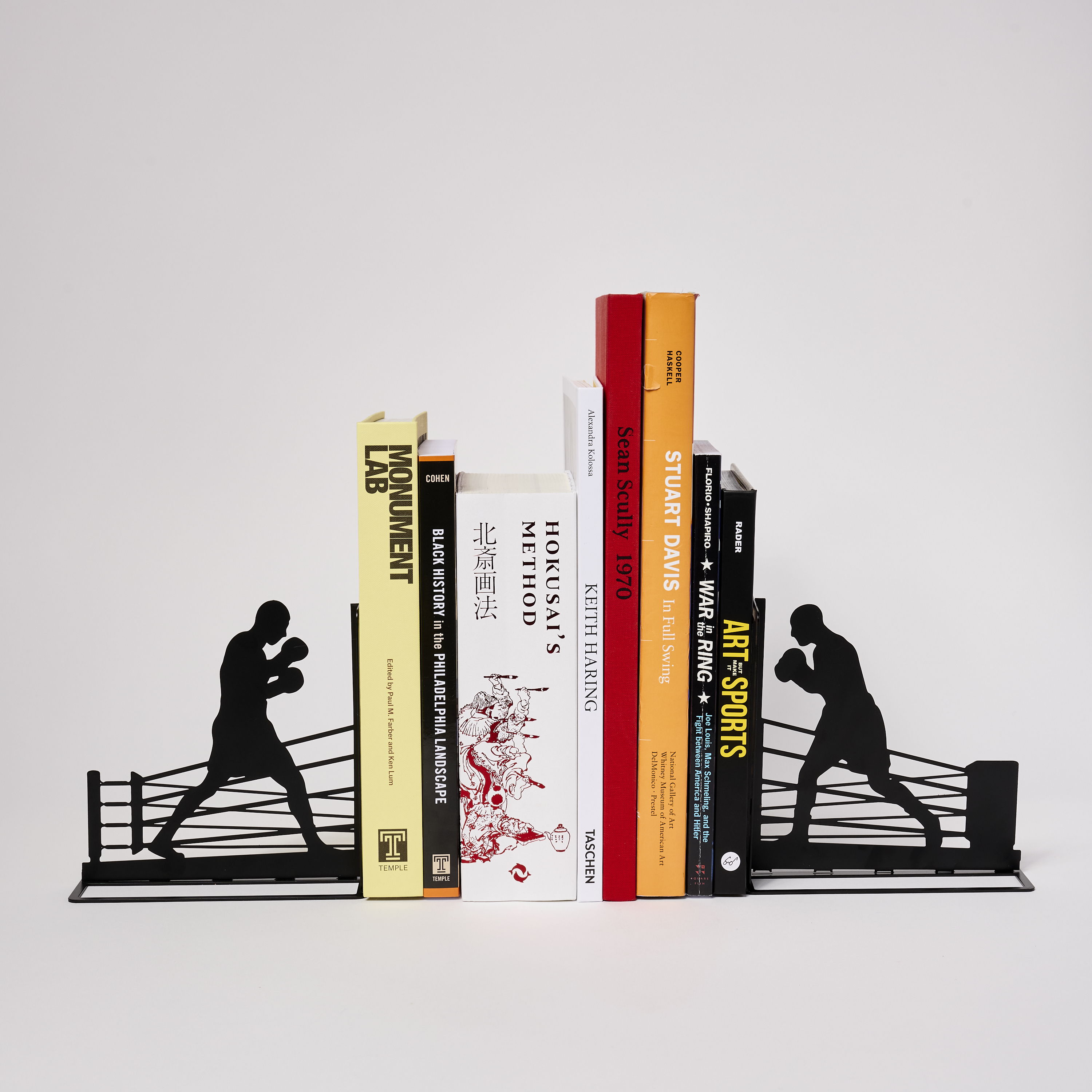 Bookends featuring boxing silhouettes supporting colorful books.