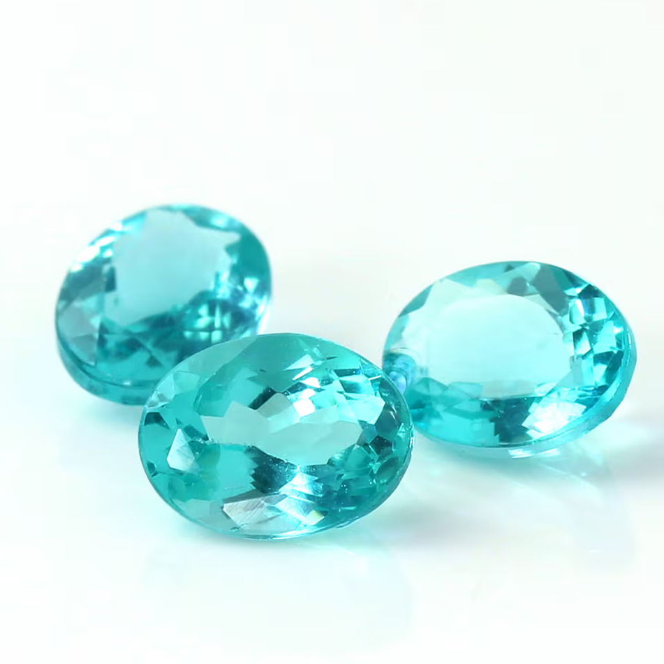 Three oval blue gemstones on a white background.