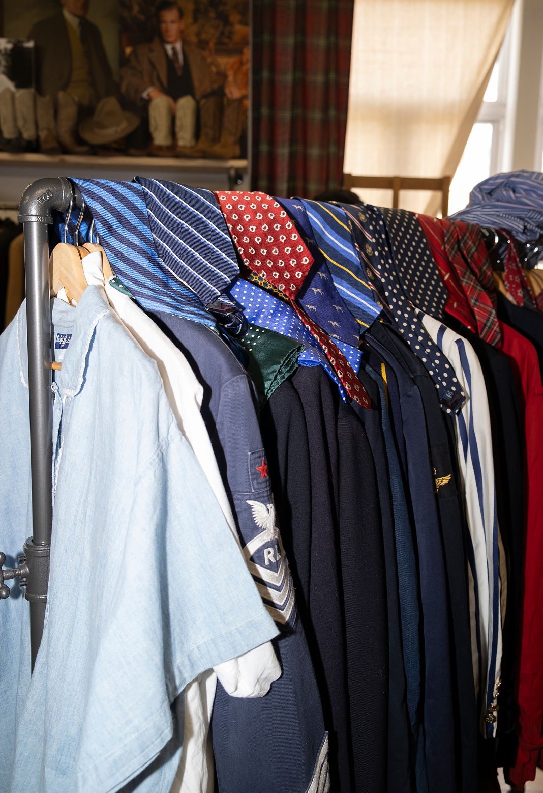 A rack of various shirts and ties displayed neatly.