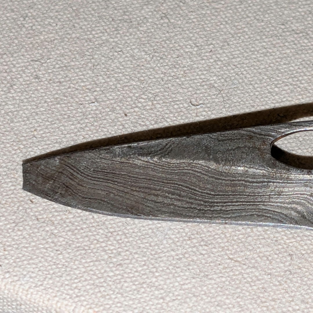 Close-up of a metal tool with a textured surface.
