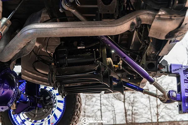 Shocker XL train horns and compressor mounted on purple suspension under Ismael's Chevrolet Silverado photo 2