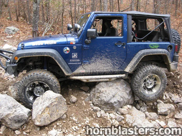Front-three-quarter Steve's 2010 Jeep Wrangler JK seven-slot grille round headlights exterior Shocker XL train horn featured install photo 1
