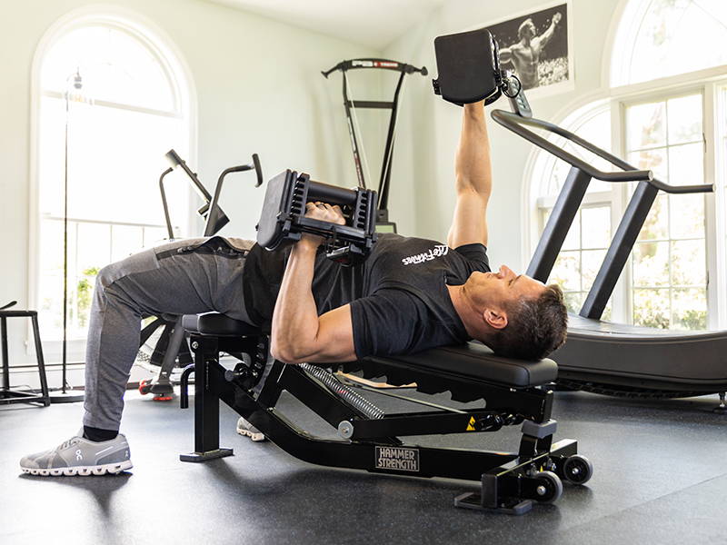 Celebrity fitness trainer, Don Saladino, decline dumbbell pressing on Hammer Strength Home Multi-Adjustable Bench
