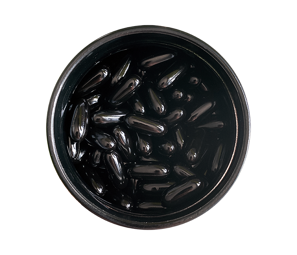 Black jar filled with Complement Essential vegan multivitamin capsules. 