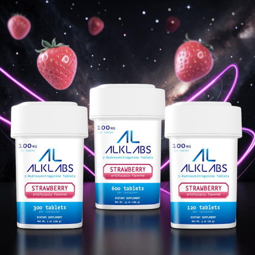 Three bottles of strawberry-flavored tablets with strawberries in the background.