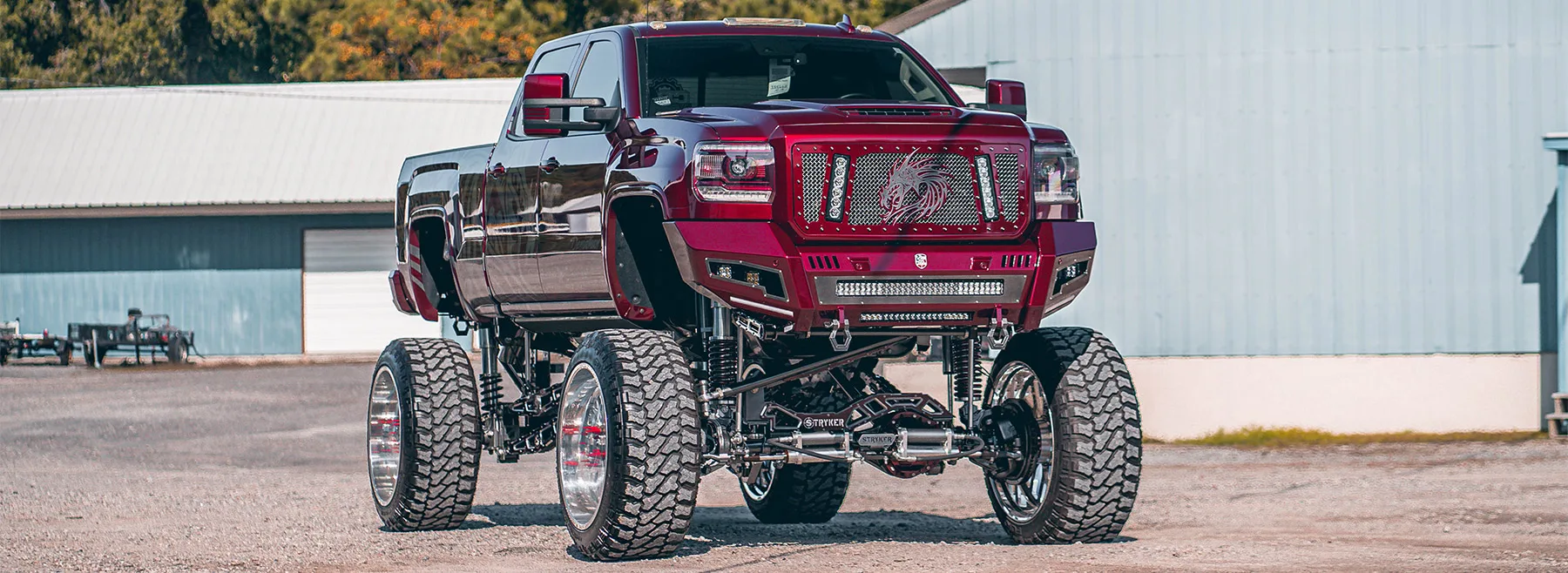 Burgundy lifted truck with custom grille and train horn install