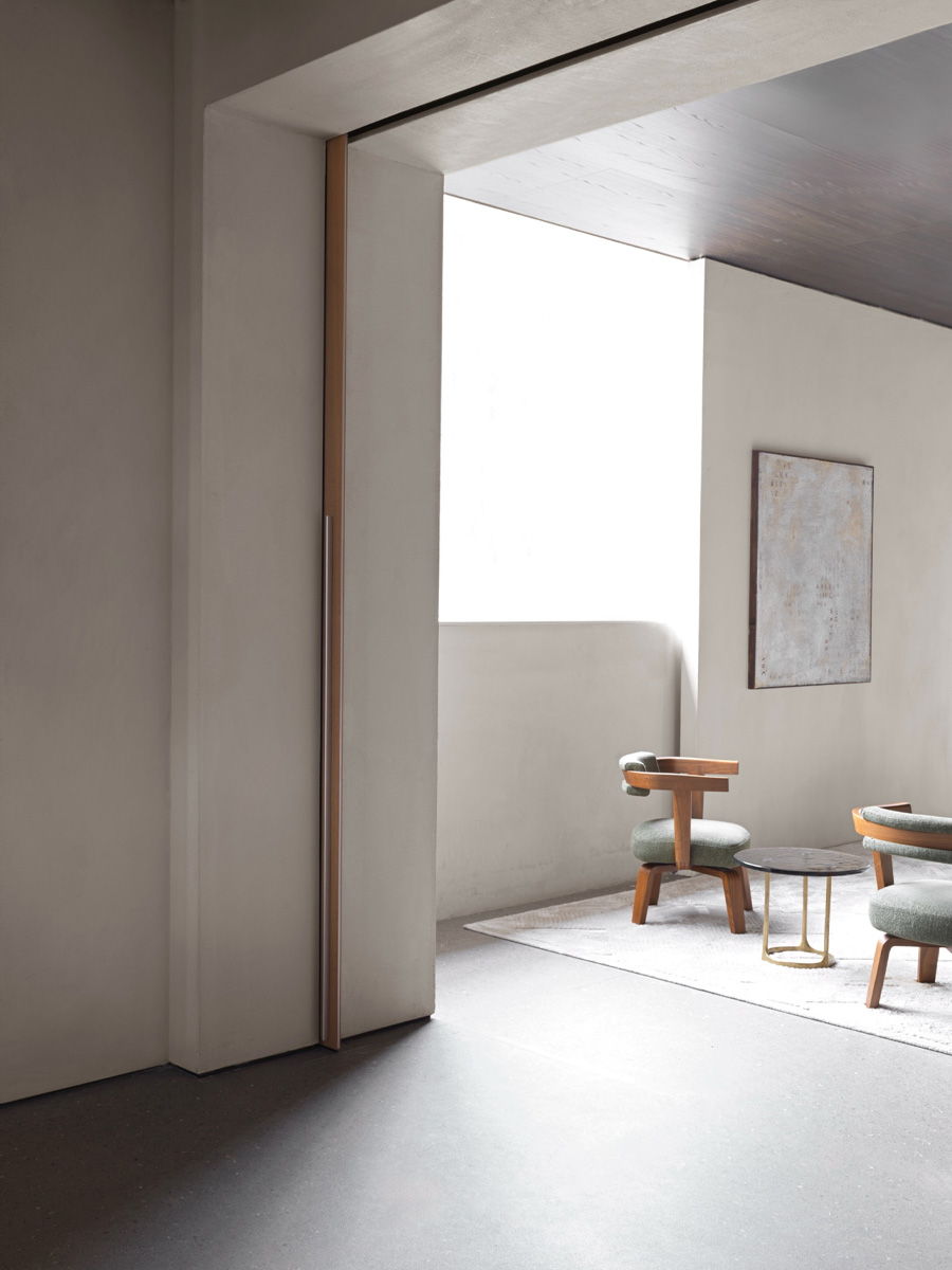 Interior space with glass Molteni doors and minimalist furniture.