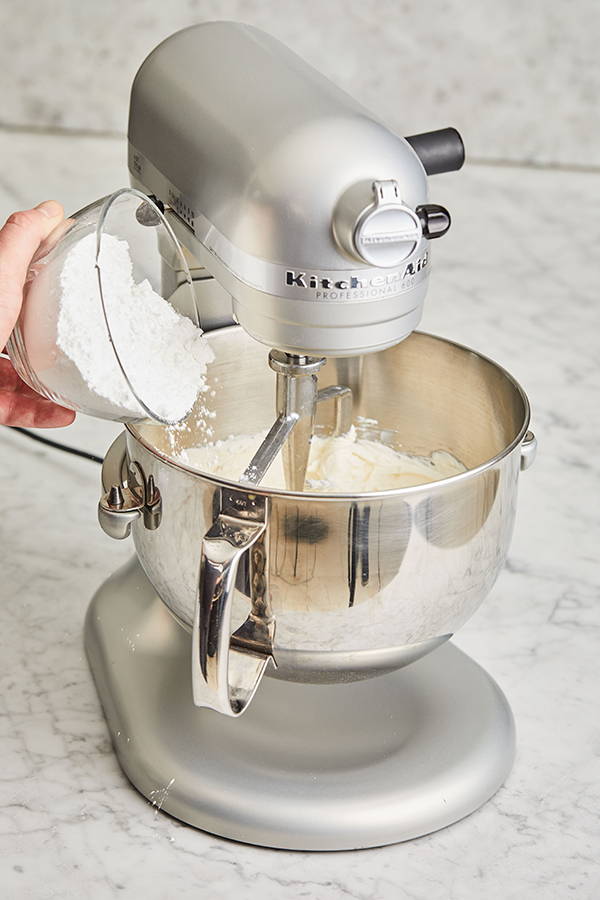 Powdered sugar being added to stand-mixer