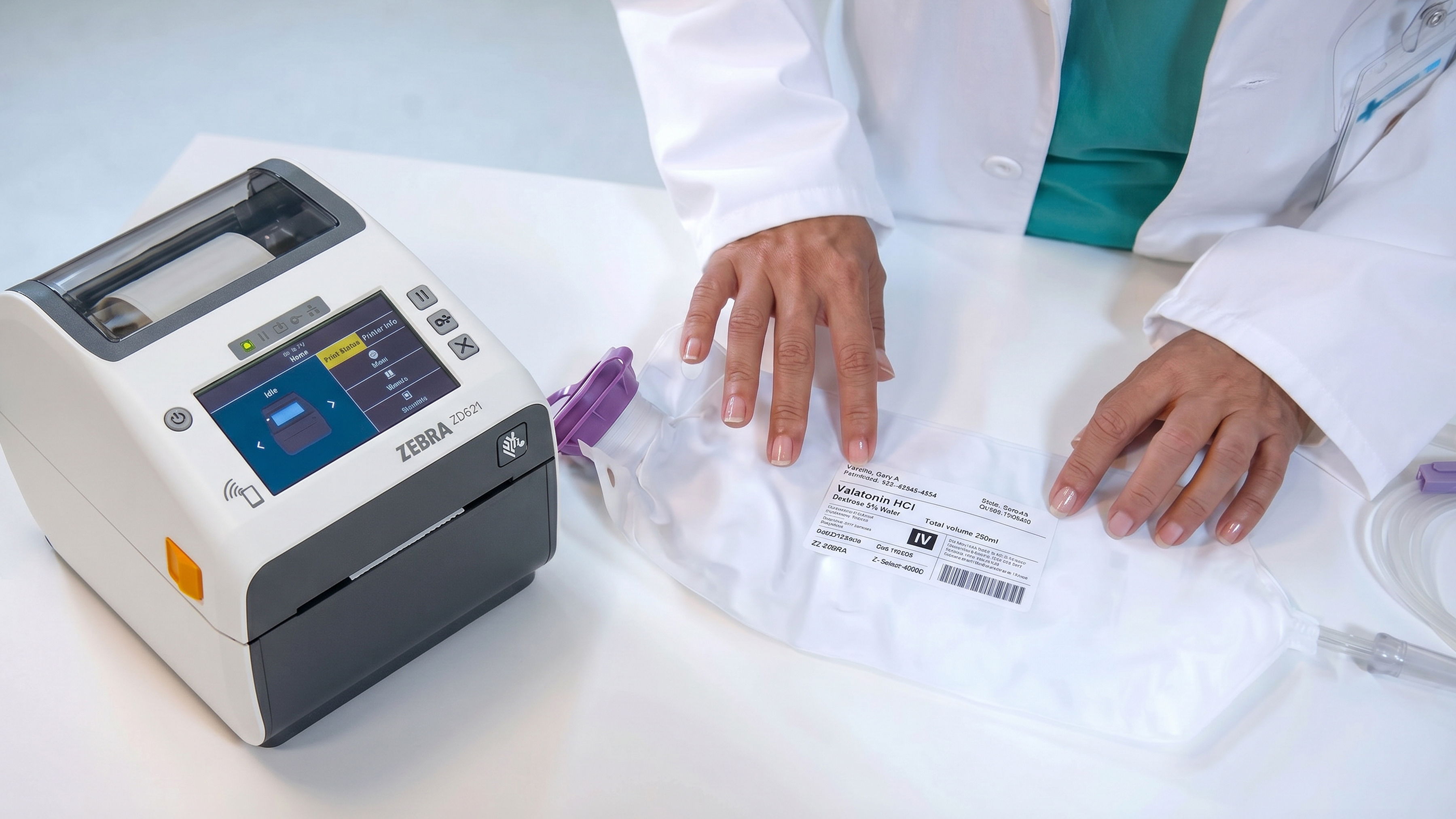 A medical professional using a printer on a table with medical supplies.